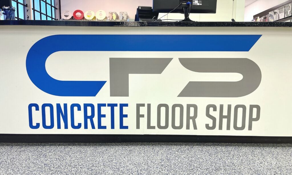 A concrete floor shop sign on the front of a store.
