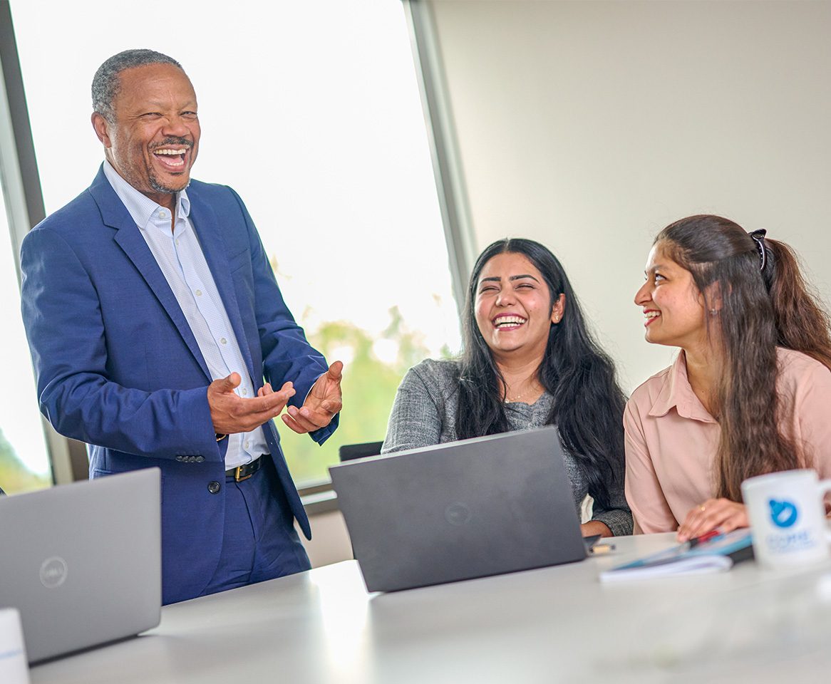 CORE_images_home_1 Team members sharing a light-hearted moment during a collaborative meeting.