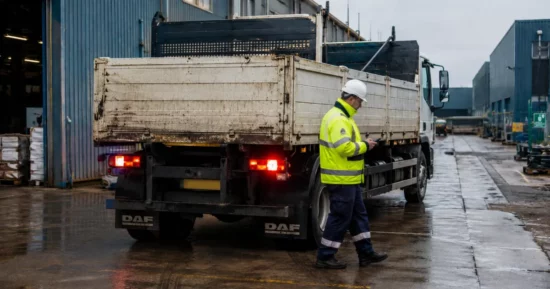 Reversing truck nearly hits worker