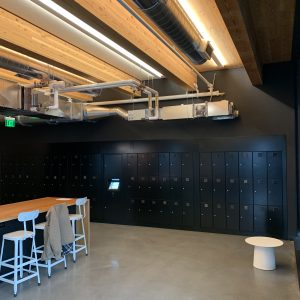 Black access control lockers around the perimeter of a large room