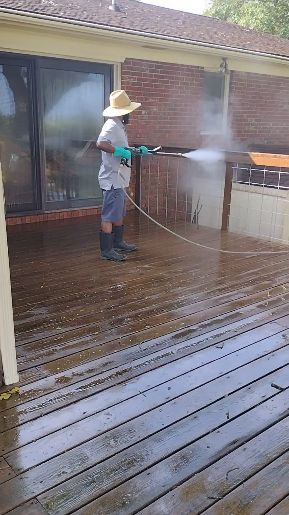 Pressure Washing and Exterior Cleaning | Charleston, SC DSS Cleaning technician cleaning a wood deck with controlled water pressure