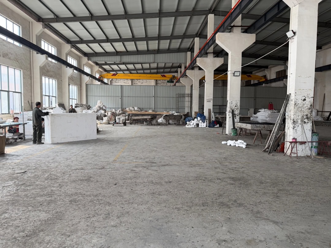 Wide factory workshop with an overhead crane and production work areas
