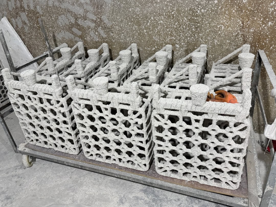 Honeycomb furnace basket castings arranged in rows in the workshop