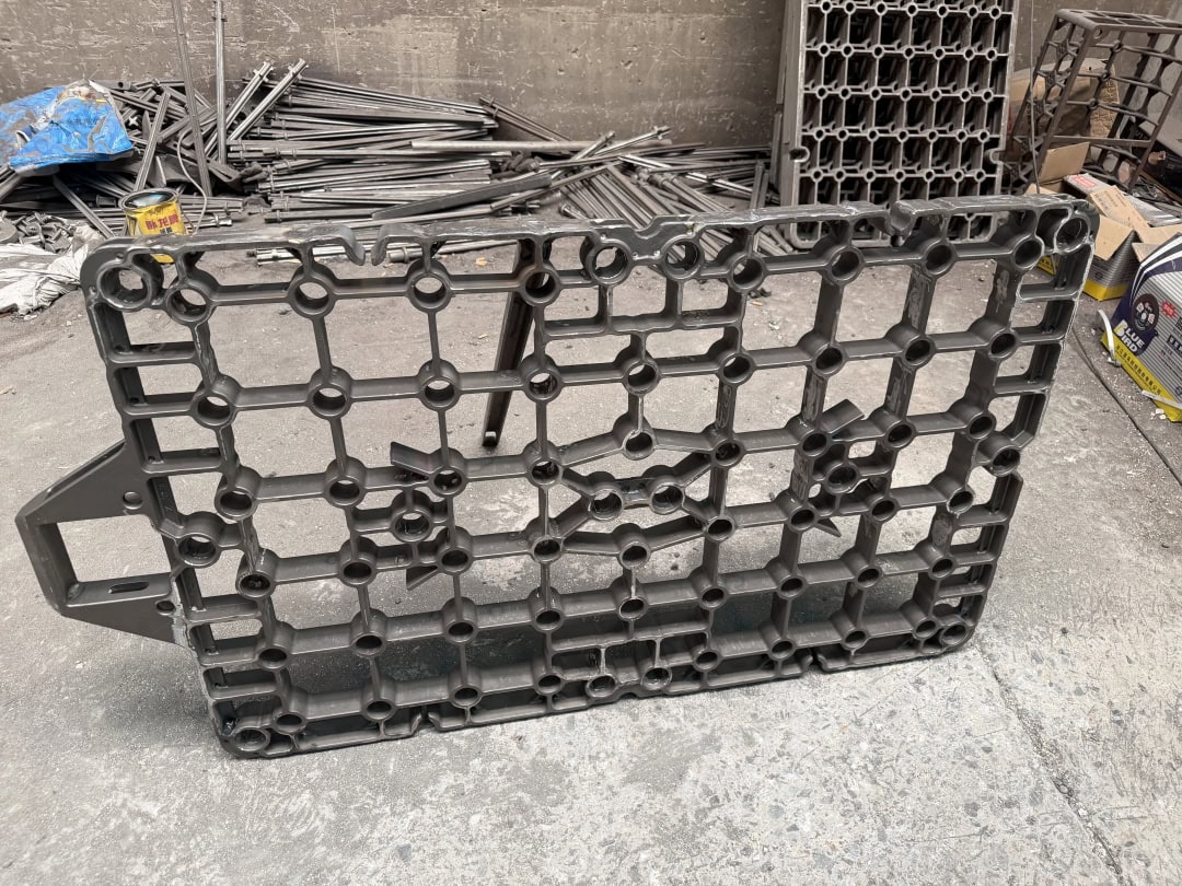 Rectangular open-grid furnace tray castings with rounded cells stored upright