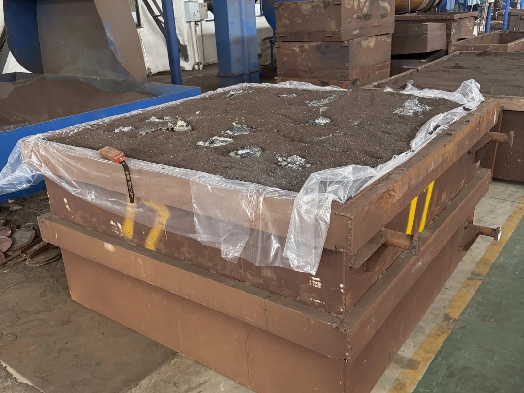 Large mould box filled with sand in the foundry workshop