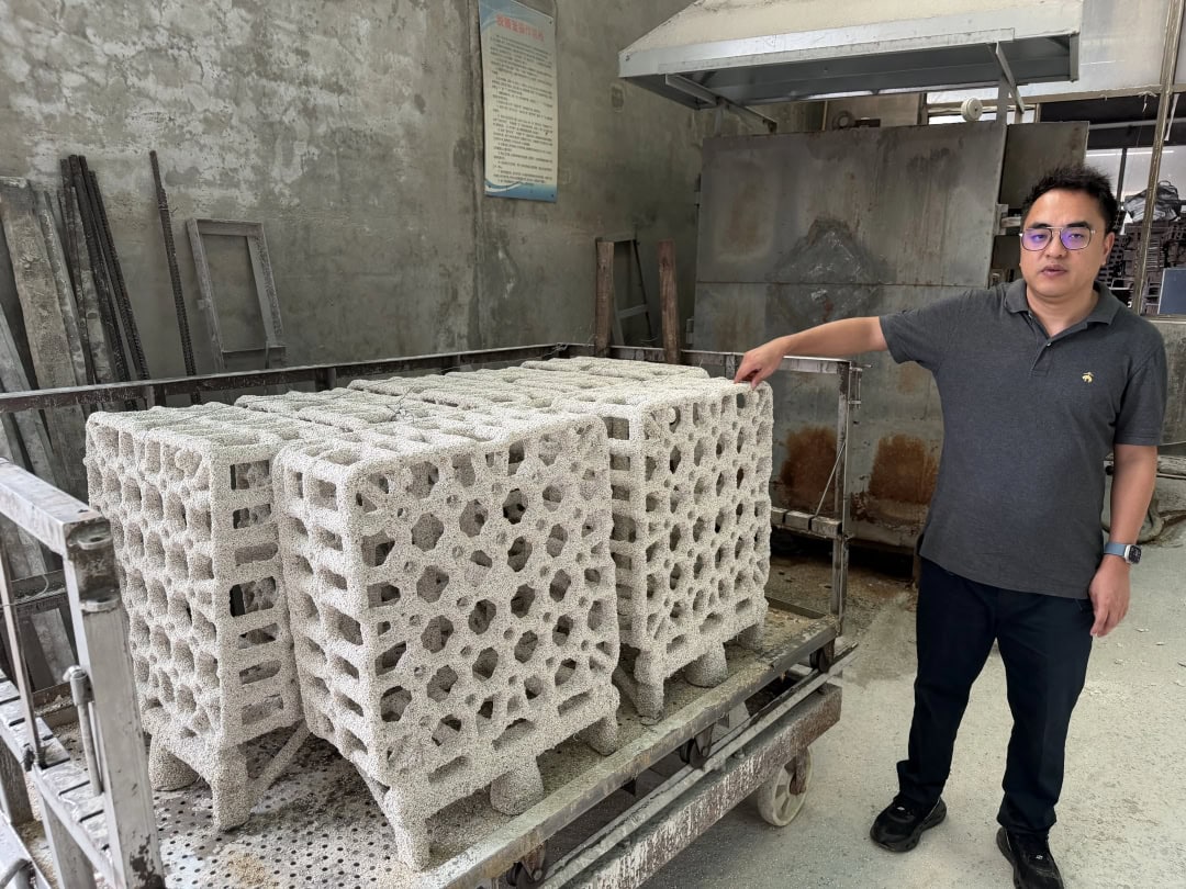 White honeycomb casting patterns arranged on a cart in the workshop
