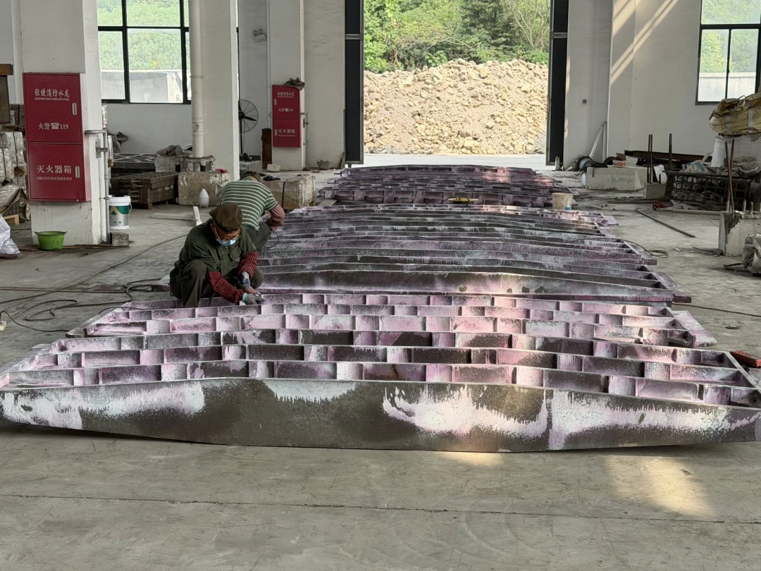 Rows of cast furnace components arranged on the workshop floor
