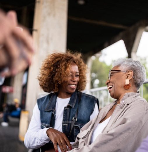 Senior friend talking in the subway station