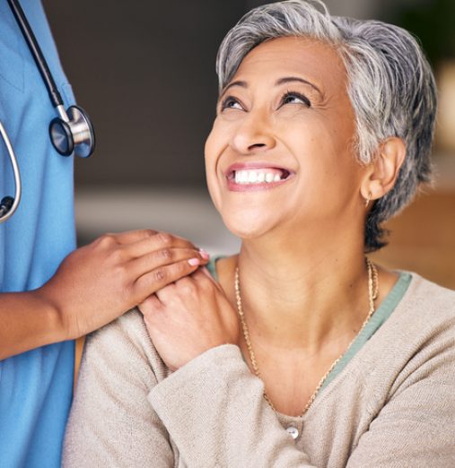 Nurse, senior woman and smile with comfort, holding hands or support in nursing home for retirement. Doctor, medic or caregiver with kindness, empathy or gratitude for help, trust or service in house