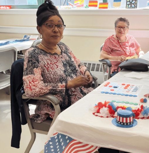 Two women participating in recreational activities at Element Care PACE day health center in Massachusetts