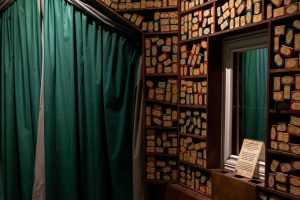School Of Magic Escape Room showing a wall of wands layered along shelves