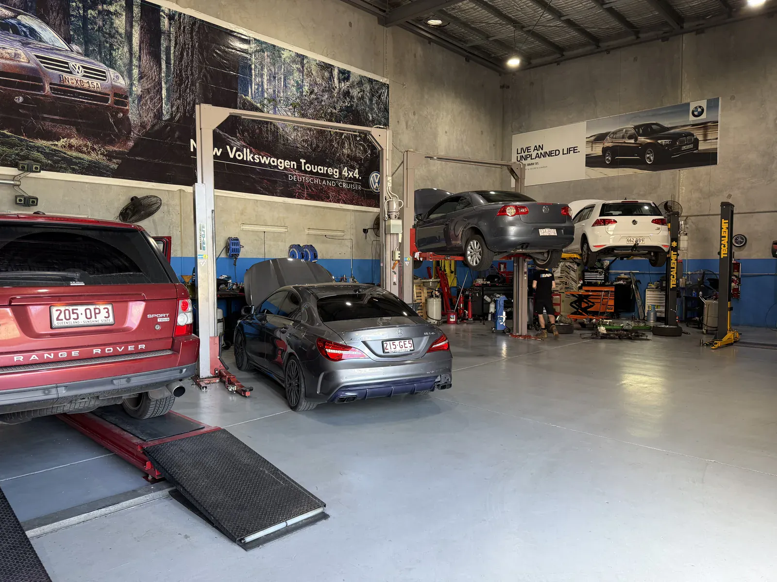 Euro-Aus Performance European car workshop in Capalaba with a Range Rover Sport, Mercedes-AMG CLA 45 and Volkswagen Golf on the hoists