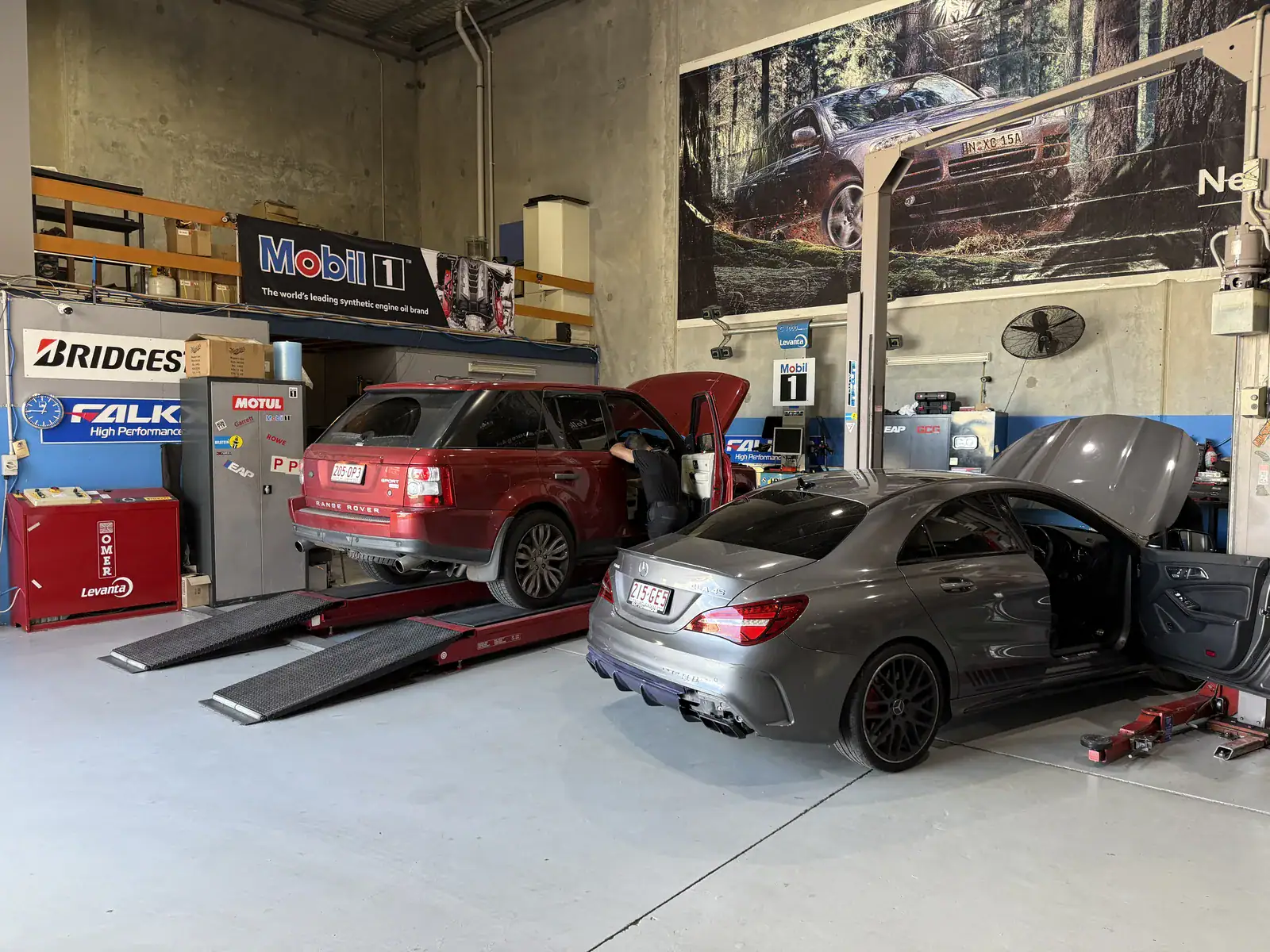 Mercedes-AMG CLA 45 in for service at Euro-Aus Performance Capalaba with a Range Rover Sport on the ramp behind