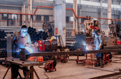 An image of the welders in a manufacturing plant.