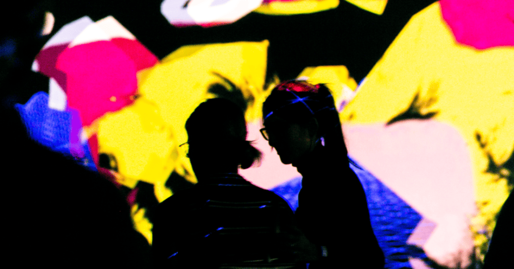 Inside the 360XR Room at Factory Berlin. There are bright lights and colours, and an abstract shadow.