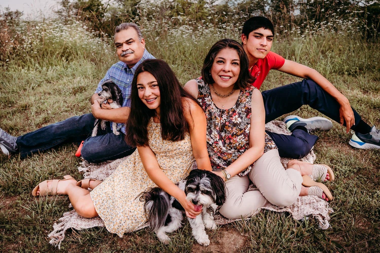 loving family with older kids and dogs portrait photo near a lake
