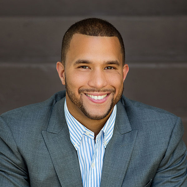 Office evolution franchising, professional man in business suit smiling, office evolution franchise opportunities, business owner, entrepreneurial success, office space solutions.