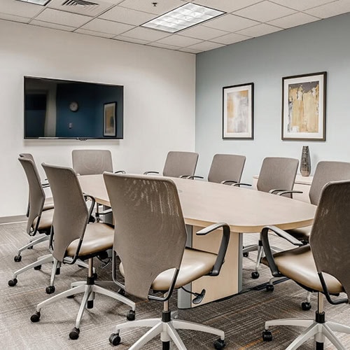 Office Evolution franchising office meeting room with conference table and chairs for business - optimized for keywords.