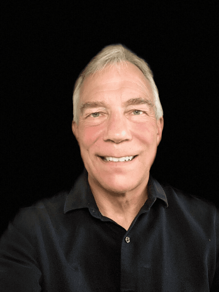 Franchise owner smiling in a black shirt for Office Evolution franchising.