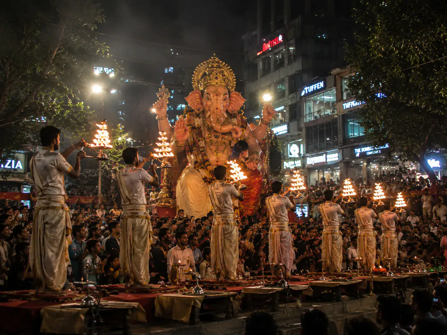 Ganesh Chaturthi visarjan procession aarti with priests carrying lit lamps