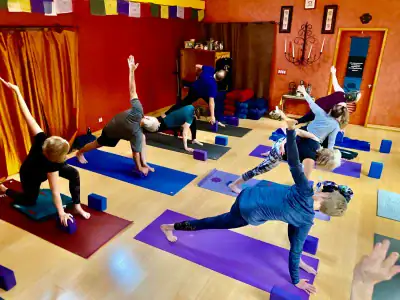 people posing in yoga class in studio