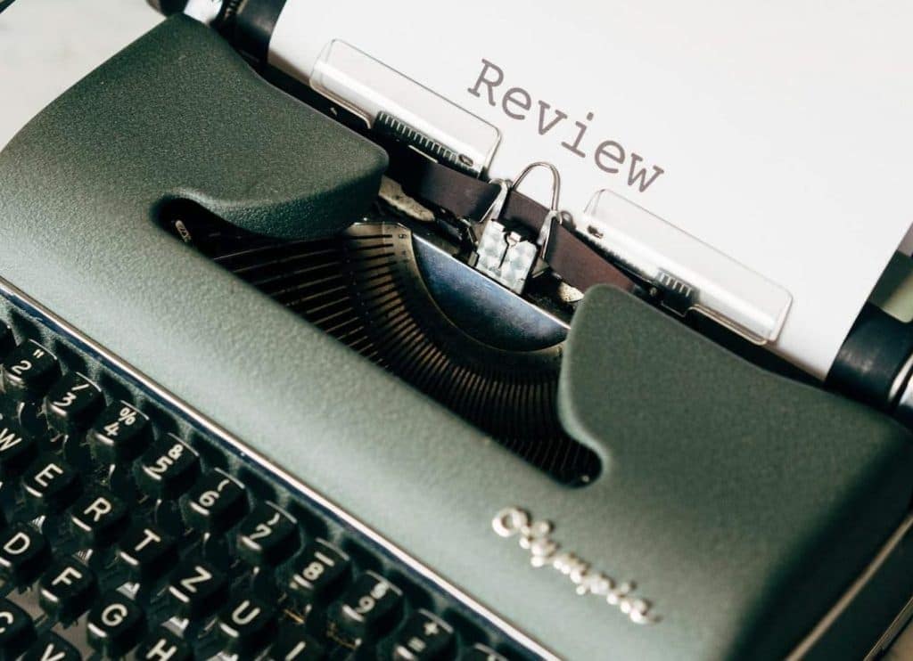 A typewriter with the page heading "Review"