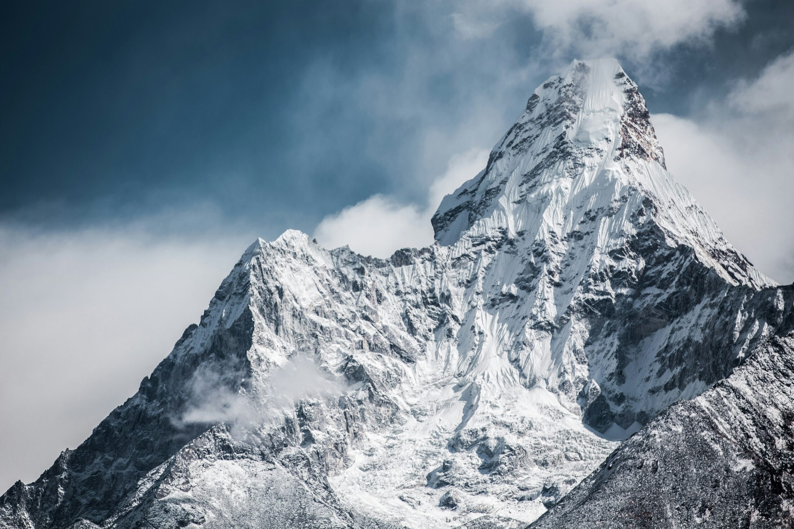 Snow-covered Himalayan eight-thousand-meter peak under cloudy sky showing the kind of brutal weather conditions and serac hazards that contribute to high fatality rates on the most dangerous mountains in the world including Annapurna I with its 32 percent death rate and Nanga Parbat with its 21 percent fatality rate primarily caused by objective avalanche and serac hazards rather than technical climbing difficulty alone — these objective hazards distinguish death-rate winners from technical-difficulty winners