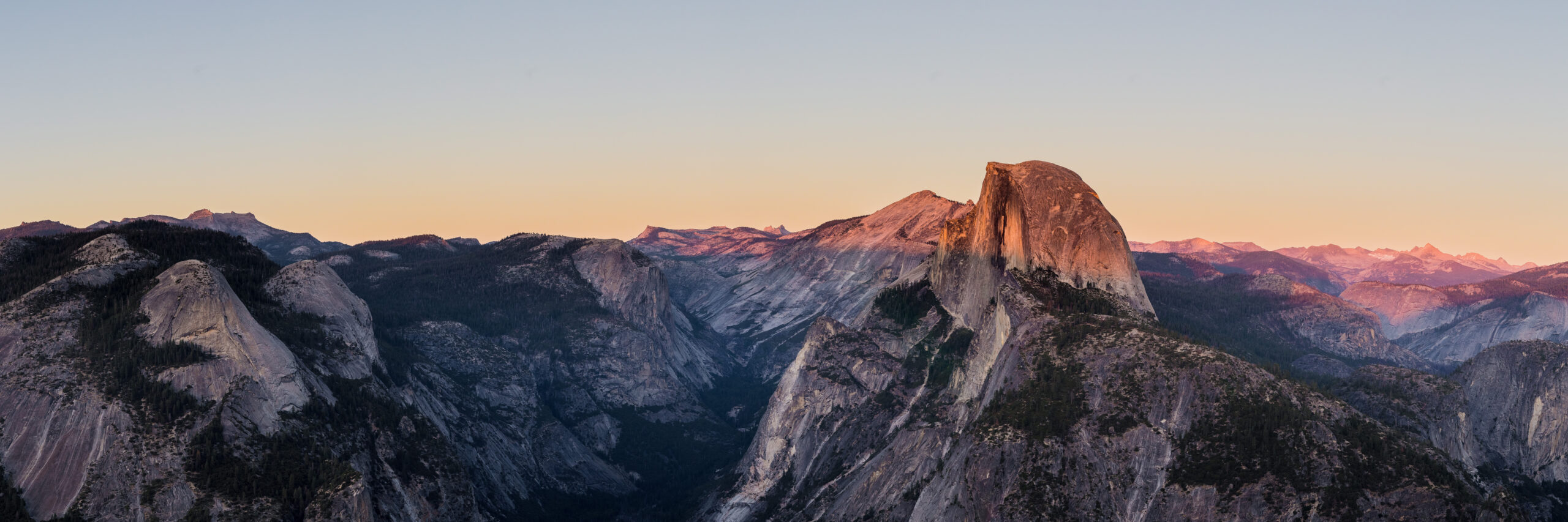 Iconic California sunset landscape over Half Dome in Yosemite National Park representing the broader California peak-bagging culture that includes the Six Pack of Peaks Challenge and adjacent training objectives like Half Dome cables permit hikes and Mount Whitney day attempts showing why Southern California hikers progress from Six Pack peaks like Mount Wilson Mount Baldy Mount San Jacinto and San Gorgonio toward higher California training peaks and ultimately Mount Whitney at 14505 feet the highest summit in the contiguous United States