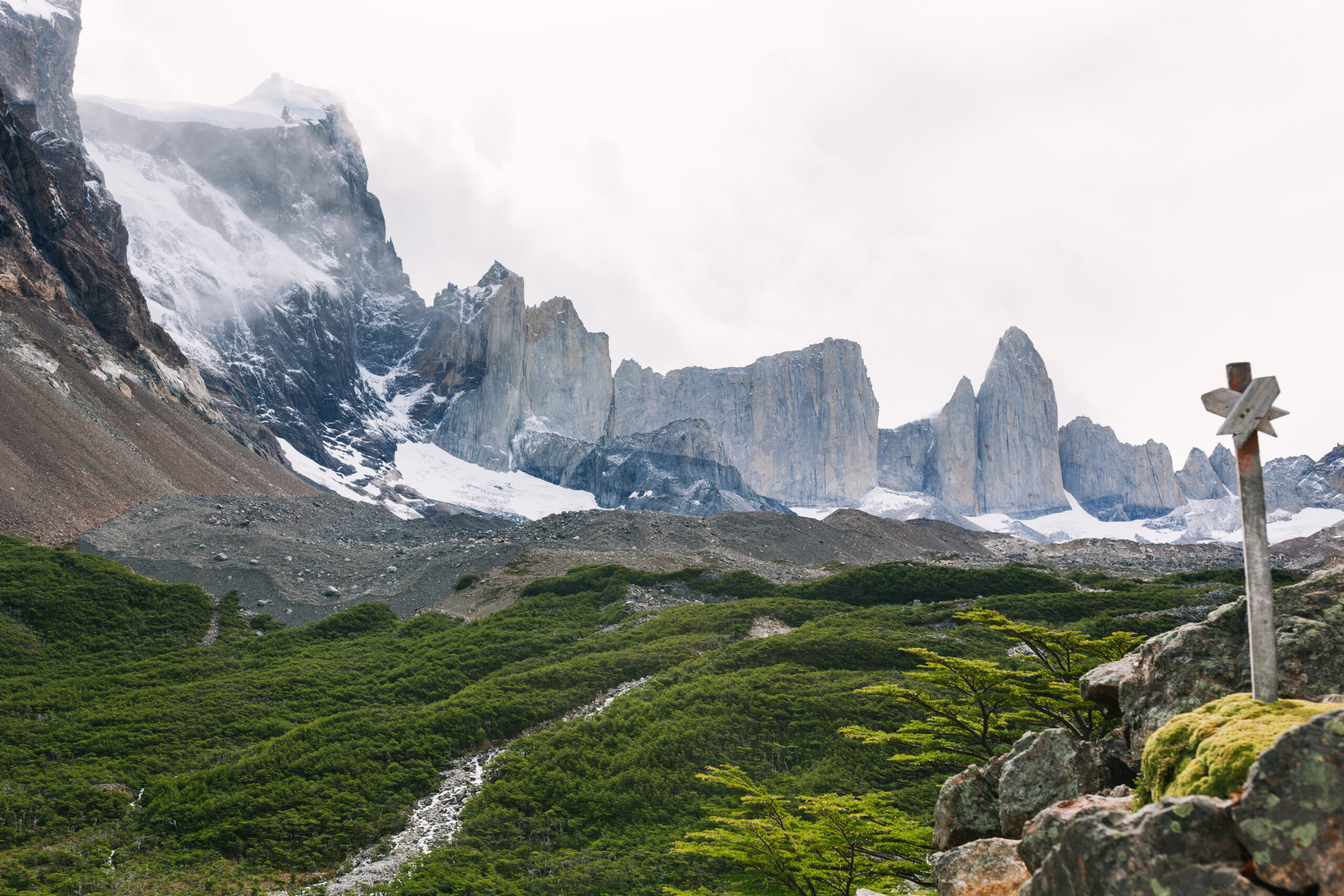 Mountain trail beside river and glacier terrain where hikers refill water