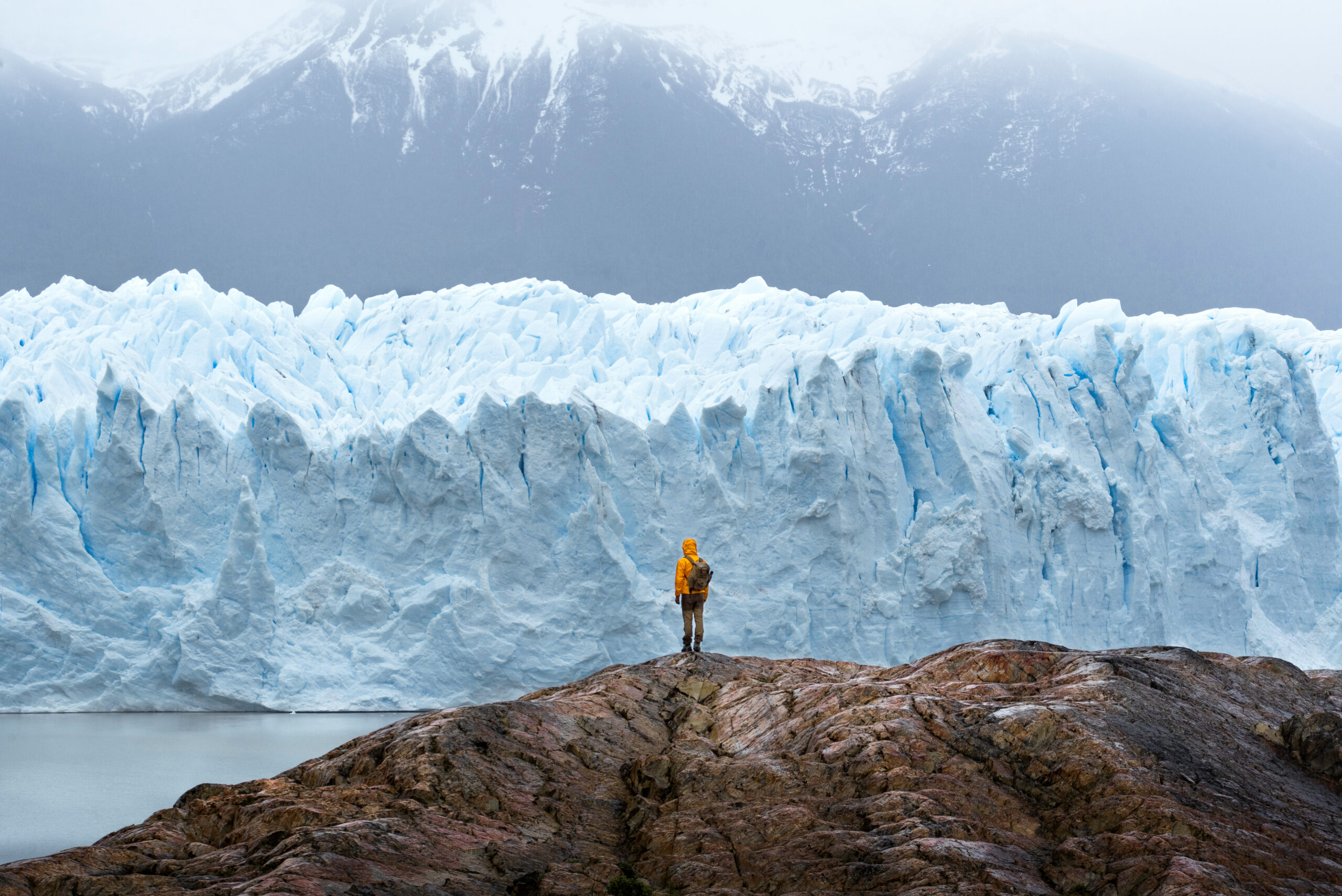 Mountaineer moving across steep snow with crampons