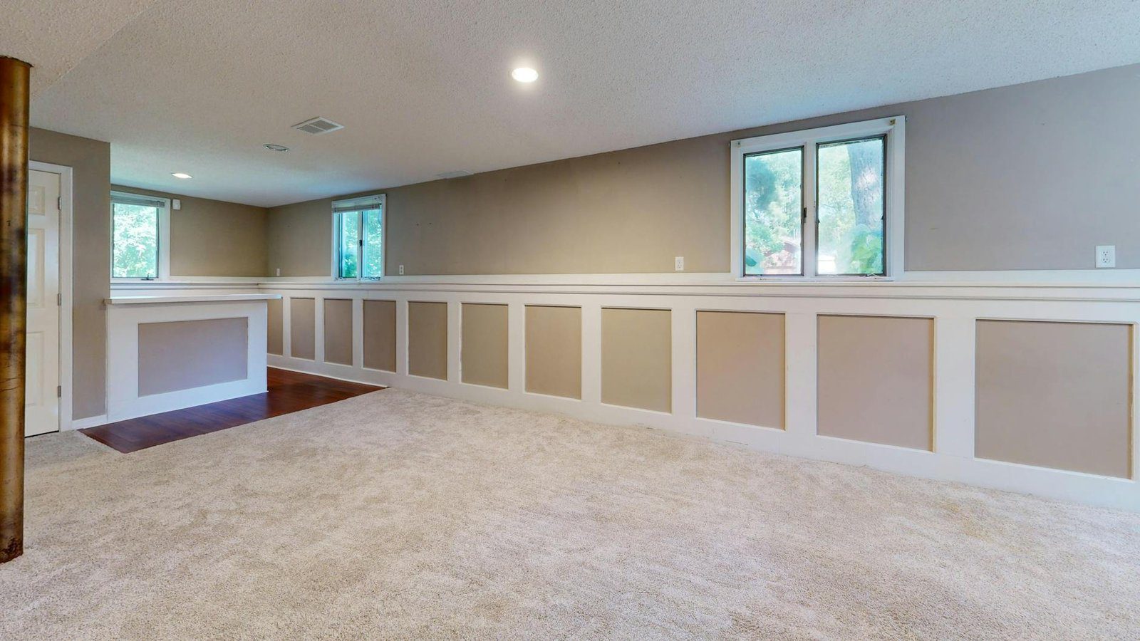 Basement Renovation cost in Kitchener-Waterloo - Bright and airy basement with ample natural light and modern decor.