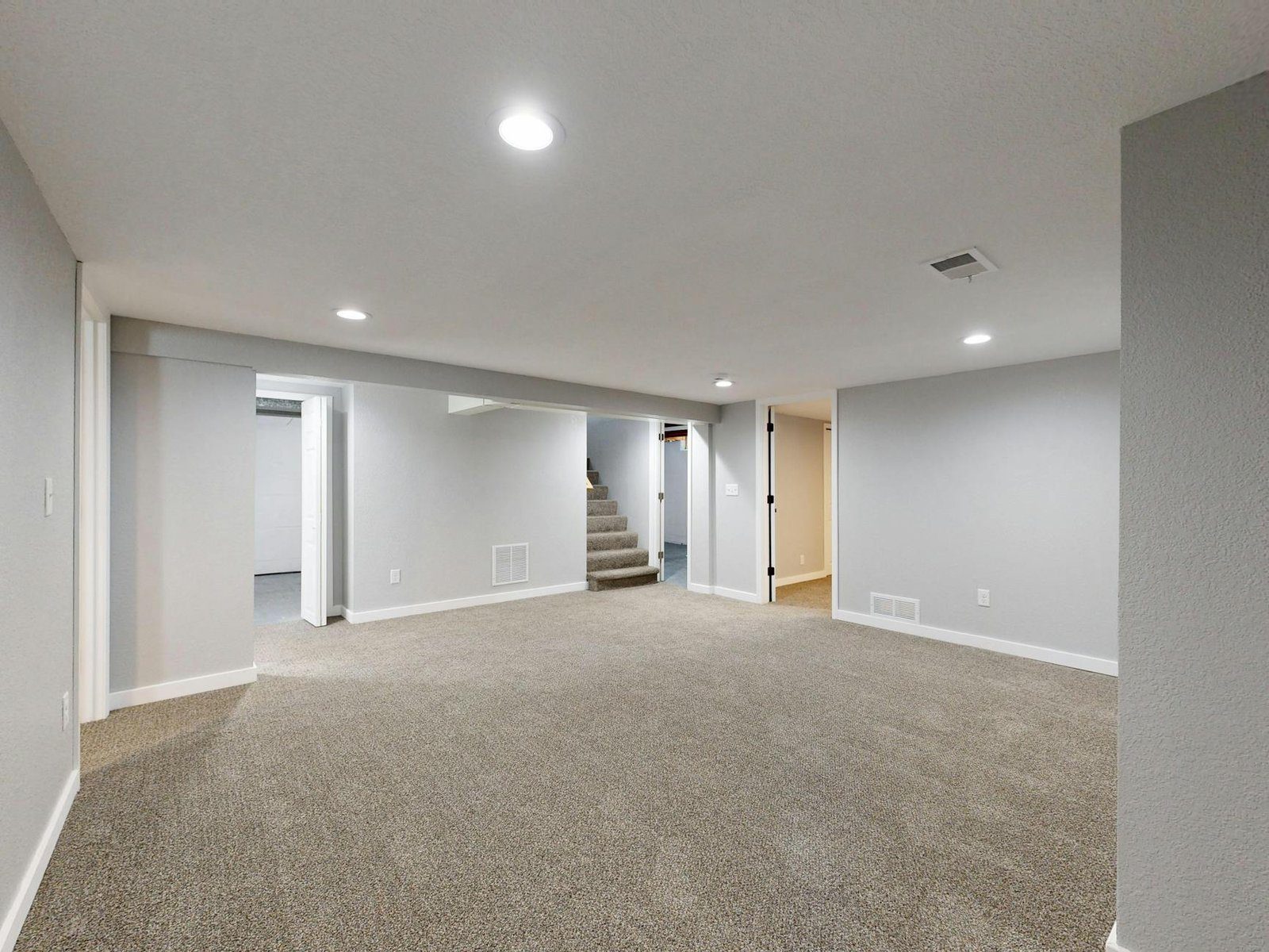 Legal Basement Suite project in Ontario - Spacious modern basement with neutral design and carpet flooring, perfect for renov
