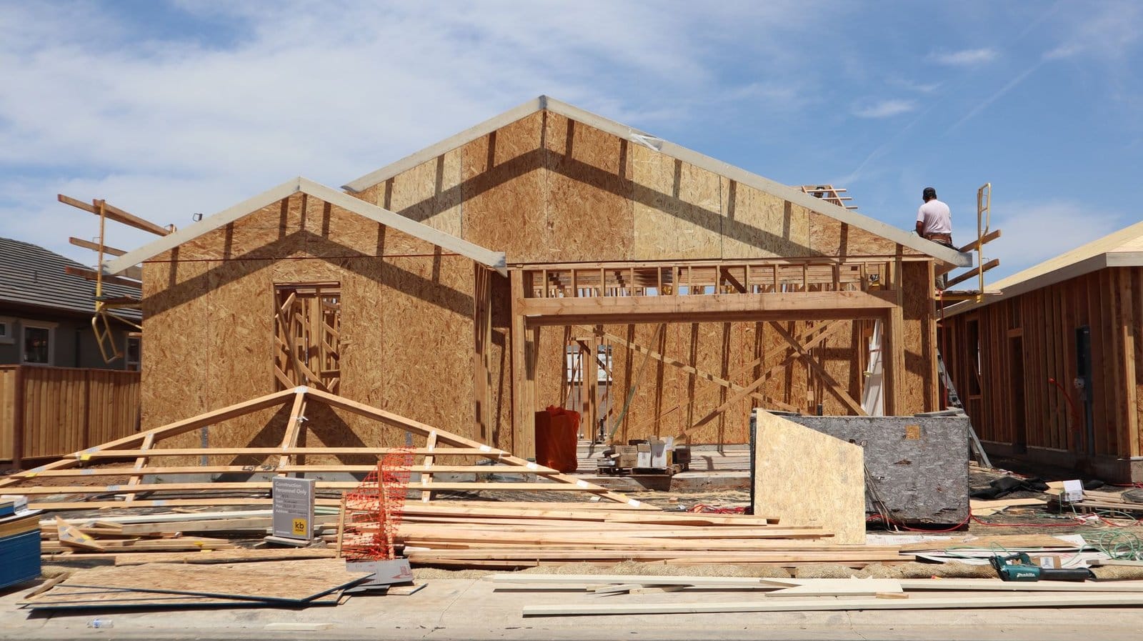 Home Addition cost in Waterloo - Framing stage of a new home under construction in Elk Grove, California.