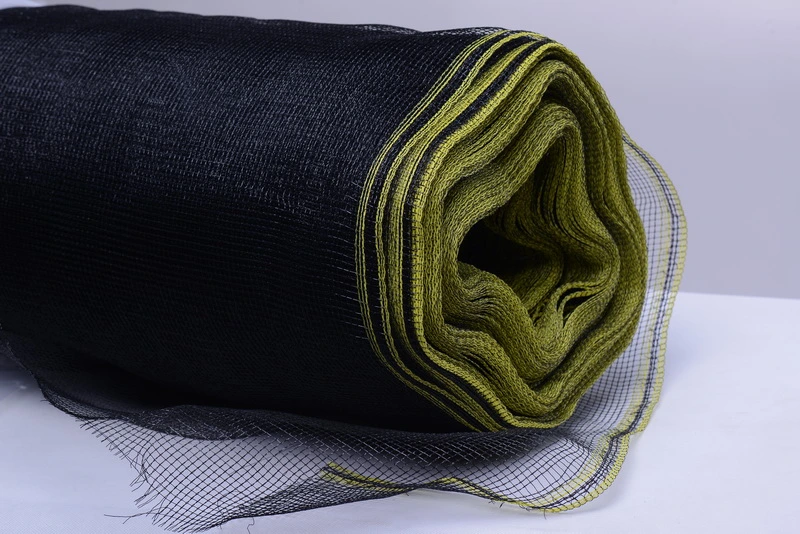 Detailed view of a roll Black Garden Netting with green lining Detailed view of a roll Black Garden Netting with green lining