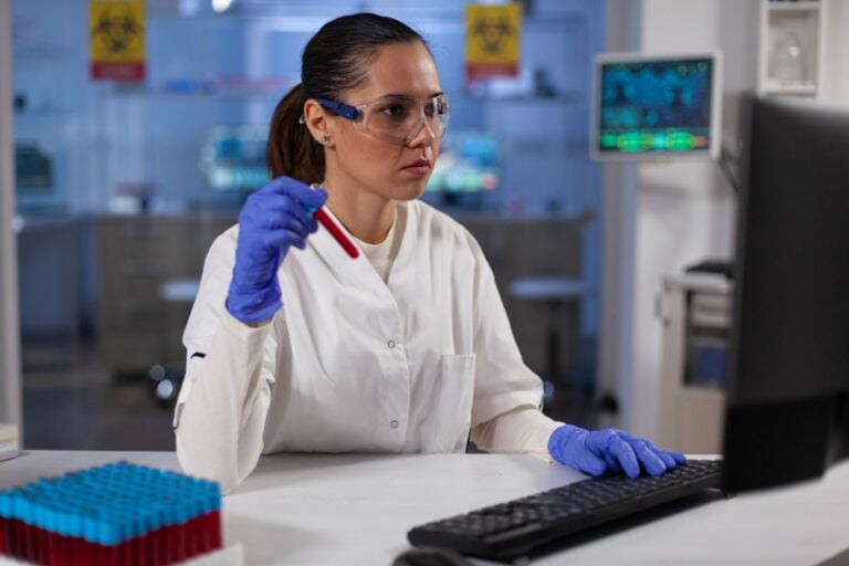 scientist-woman-doctor-holding-medical-vacutainer-with-blood-typing-expertise-scaled