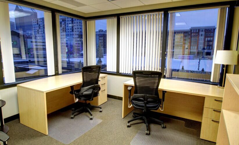 Flexible office space with large windows and modern desks at Intelligent Office.