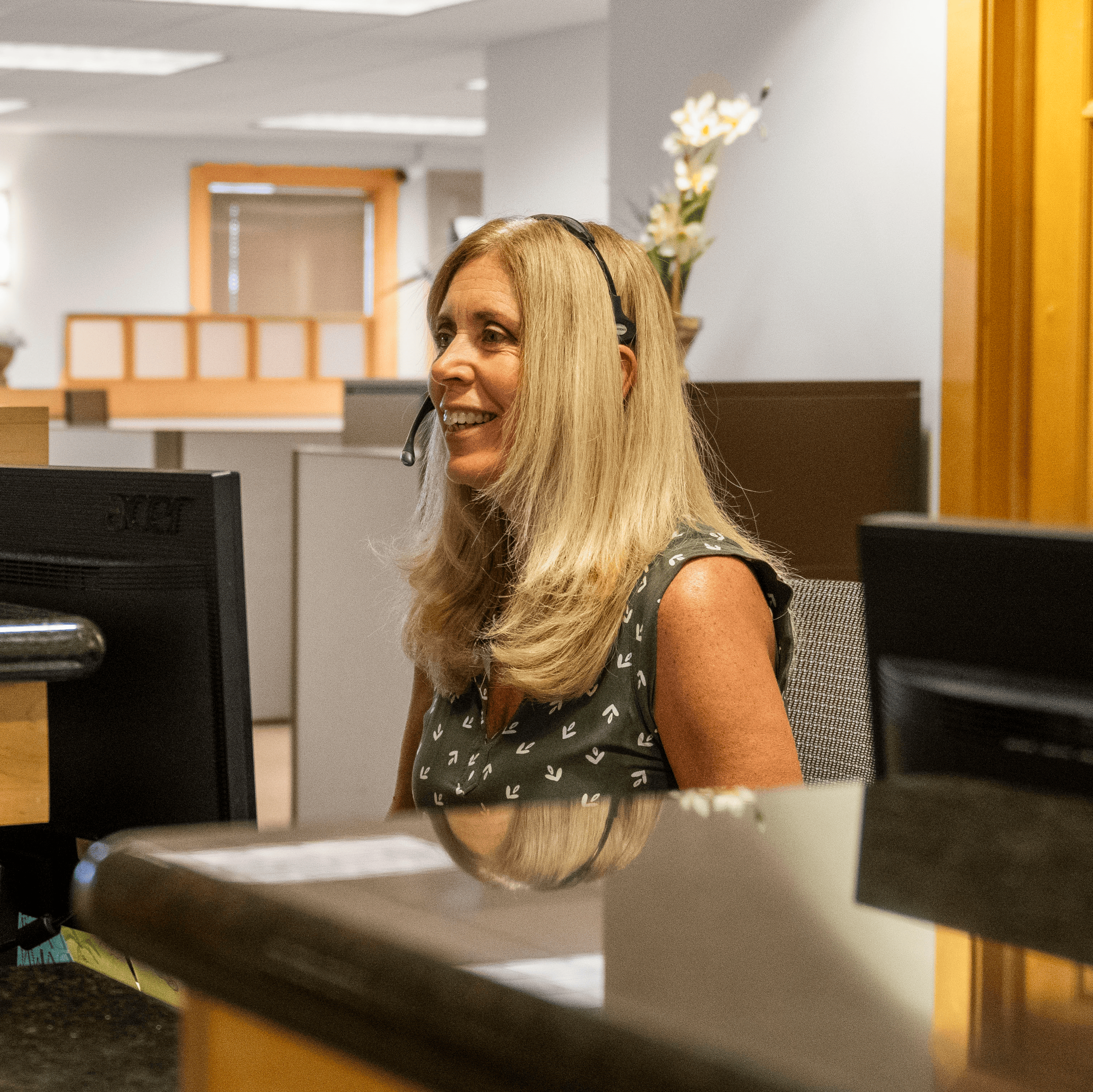 Dedicated customer service representative with a headset providing professional support at Intelligent Office franchise.
