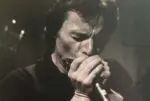 Dilbert McClinton playing harmonica