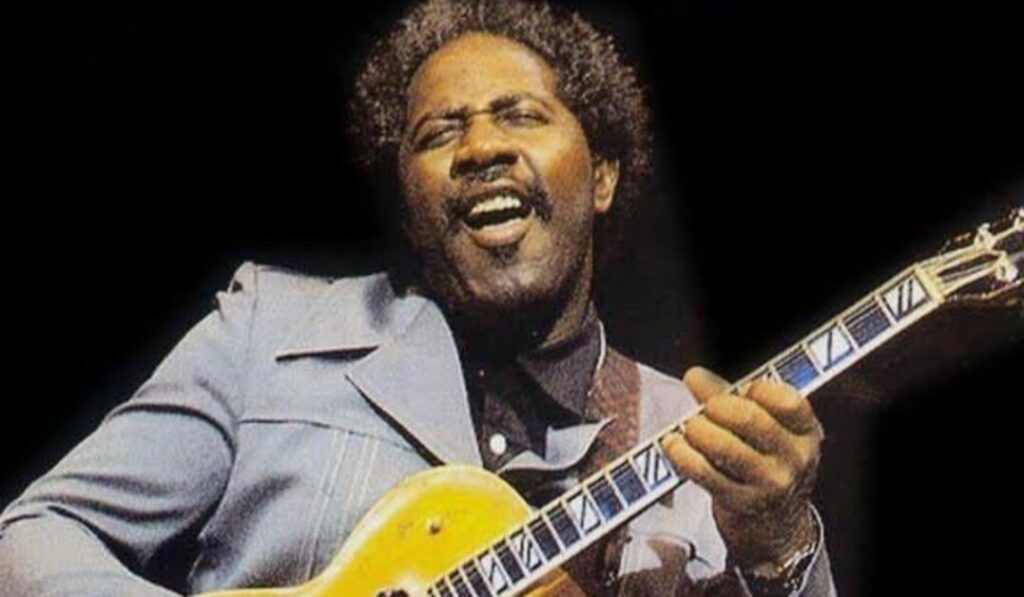 Fenton Robinson on stage playing guitar