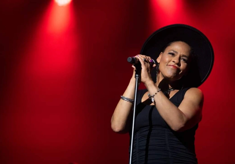 Dawn Tyler Watson at microphone on stage w/red lighting