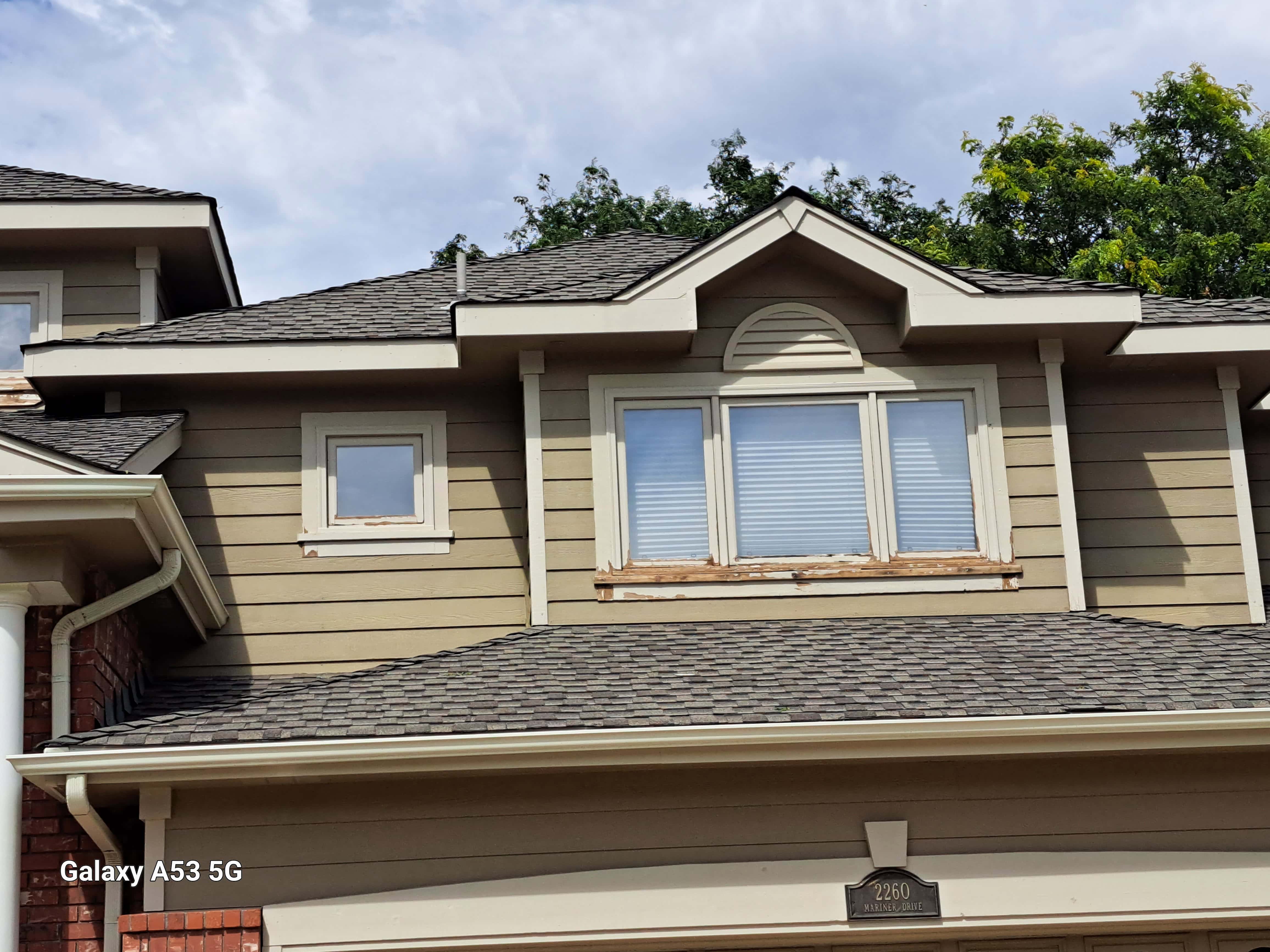 Before - peeling paint, wood rot on siding and window trim
