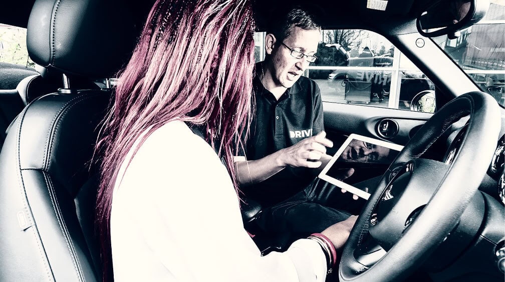 driving instructor showing student learning to drive ipad screen