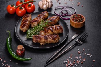 A delicious dish of pork mince wrapped with delicious pieces of bacon. Preparation of chevapchichi