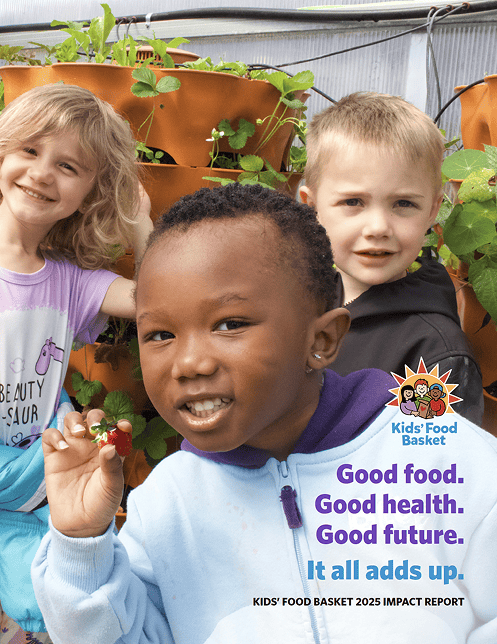 The cover of the Kids' Food Basket impact report with three children in the greenhouse smiling in front of the strawberry plants.