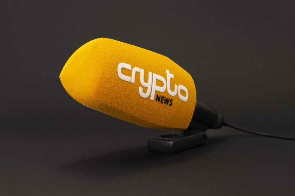 Crypto News yellow microphone windshield with white logo, professional broadcast windscreen for cryptocurrency media coverage