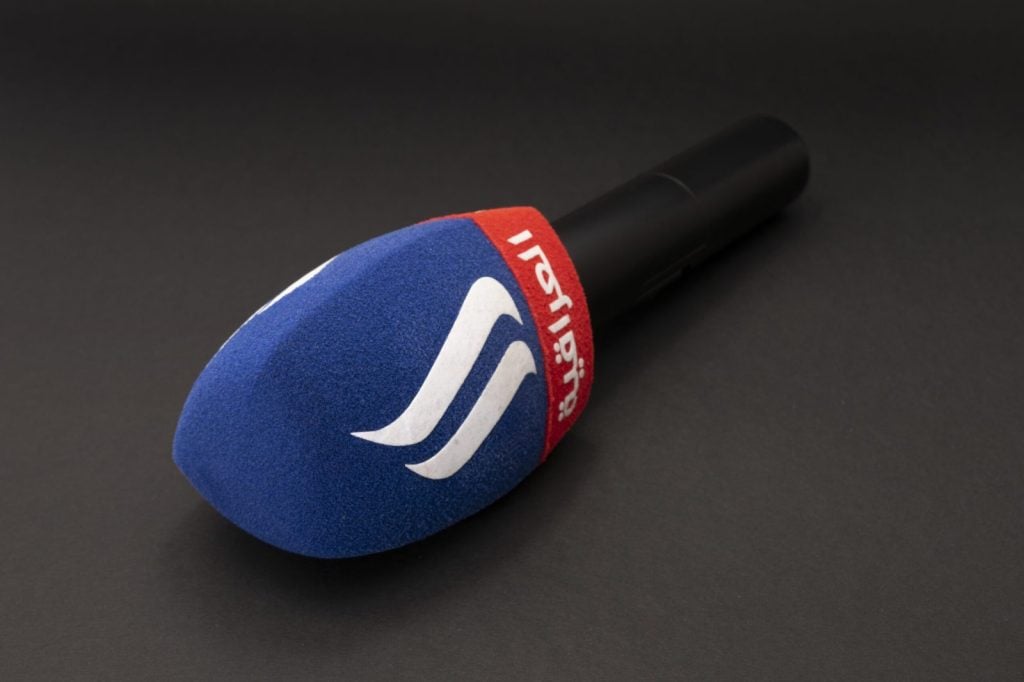 Spilka branded blue microphone windshield with white wave logo and red accent band, professional broadcast windscreen for Ukrainian media