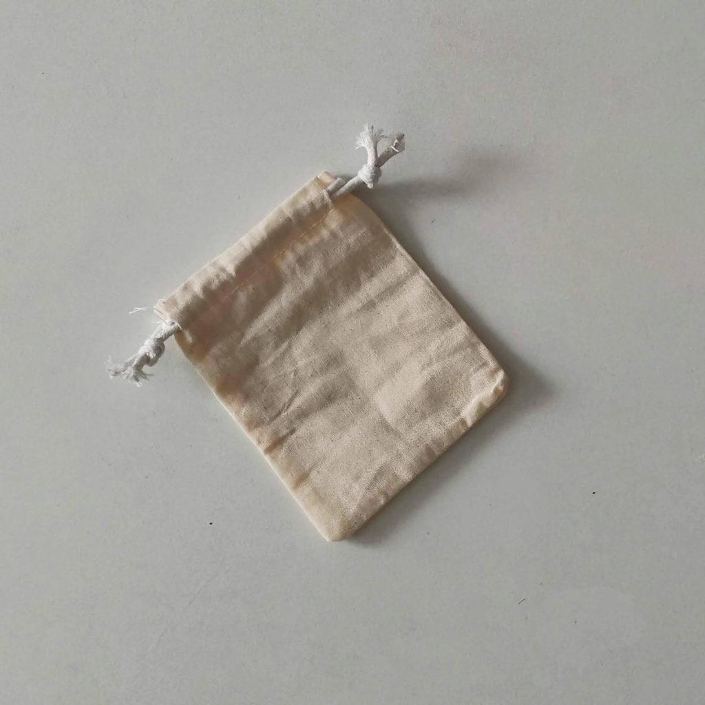 Cotton microphone dust cover with drawstring in light beige linen color on white background