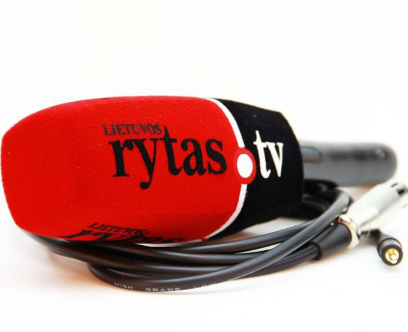 Handheld microphone with a red-and-black foam windscreen printed with “Lietuvos rytas tv,” lying on a white surface with coiled cable and connector visible.