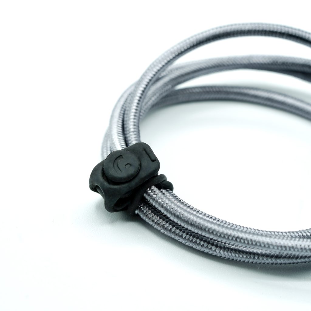Black TPE cable strap securing audio cable on boom pole equipment
