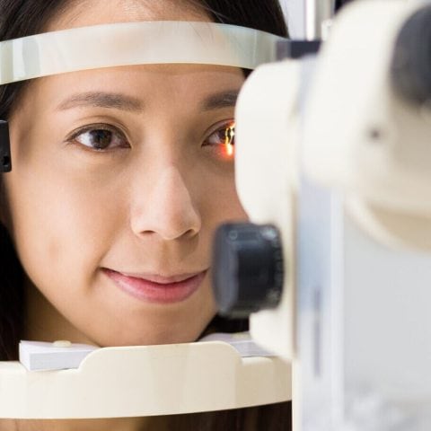 Woman checking vision with equipment Woman checking vision with equipment
